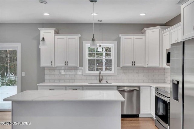 24 Nichols Rd, Wilton, NY 12831 - kitchen with appliances with stainless steel finishes, a sink, white cabinets, decorative backsplash, and recessed lighting