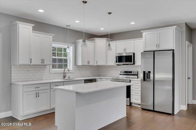24 Nichols Rd, Wilton, NY 12831 - kitchen with appliances with stainless steel finishes, a sink, white cabinetry, dark wood-style flooring, and backsplash