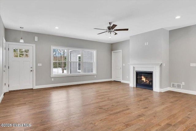 24 Nichols Rd, Wilton, NY 12831 - unfurnished living room with a ceiling fan, wood finished floors, baseboards, a glass covered fireplace, and recessed lighting