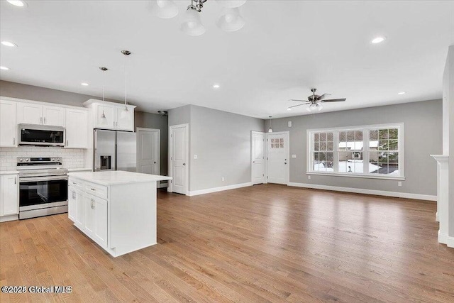 24 Nichols Rd, Wilton, NY 12831 - kitchen with stainless steel appliances, a ceiling fan, backsplash, light countertops, and recessed lighting