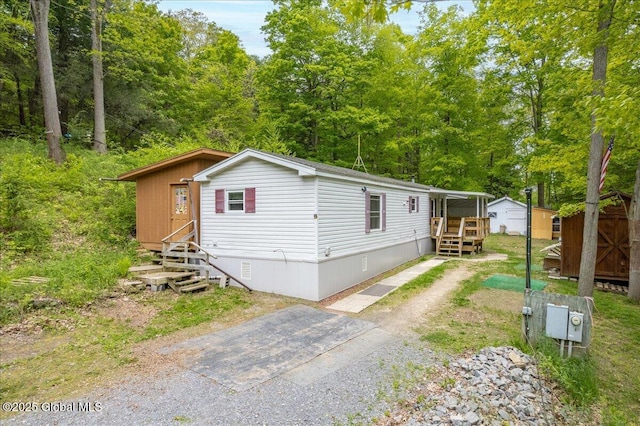 207 State Highway 5s, Florida, NY 12137 - manufactured / mobile home featuring crawl space, a storage shed, an outdoor structure, and entry steps