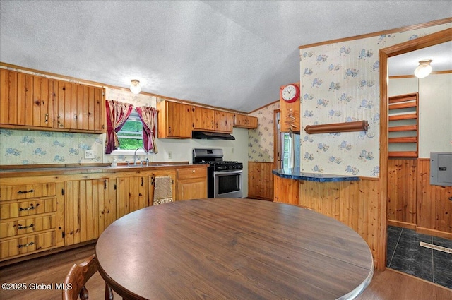 207 State Highway 5s, Florida, NY 12137 - kitchen with stainless steel gas range oven, wallpapered walls, a textured ceiling, wainscoting, and brown cabinetry