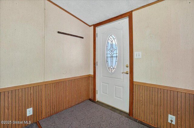 207 State Highway 5s, Florida, NY 12137 - entrance foyer featuring lofted ceiling, wainscoting, wooden walls, and a textured ceiling