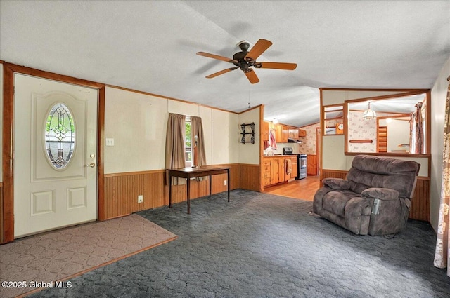 207 State Highway 5s, Florida, NY 12137 - carpeted entryway with a textured ceiling, a ceiling fan, lofted ceiling, wainscoting, and wood walls