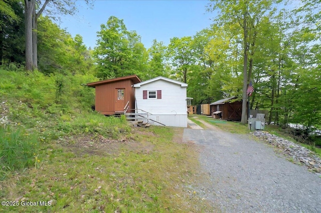 207 State Highway 5s, Florida, NY 12137 - view of front of property featuring entry steps, an outbuilding, and view of scattered trees