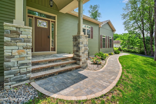 480 Selfridge Rd, Moreau, NY 12831 - view of exterior entry with stone siding, a porch, and a yard