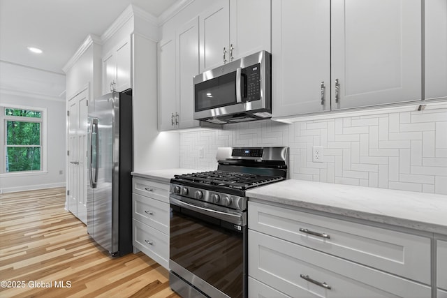 480 Selfridge Rd, Moreau, NY 12831 - kitchen featuring stainless steel appliances, tasteful backsplash, light wood-style flooring, ornamental molding, and light stone counters