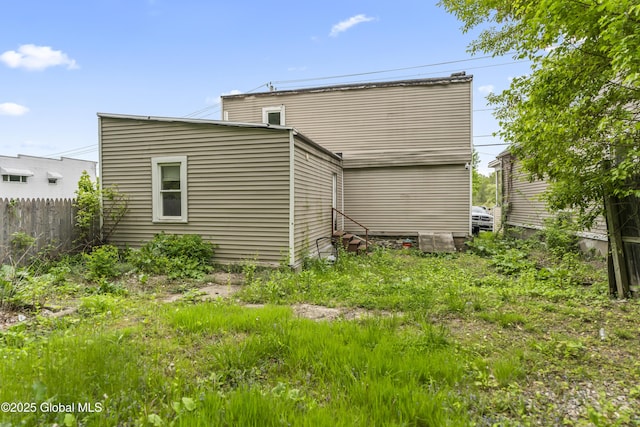 rear view of house with fence