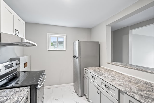 kitchen featuring stainless steel appliances, under cabinet range hood, light marble finish floors, light stone counters, and baseboards