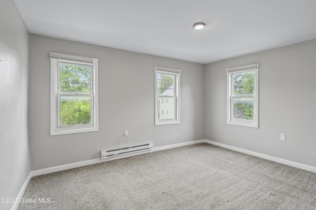 carpeted empty room with a baseboard radiator, healthy amount of natural light, and baseboards