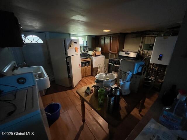 16 Mohawk St, Albany, NY 12204 - kitchen featuring freestanding refrigerator, light wood-style floors, gas range, and a sink