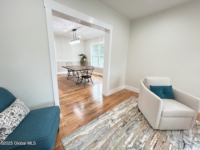 354 Mohawk Ave, Scotia, NY 12302 - sitting room with wood finished floors, baseboards, and a chandelier