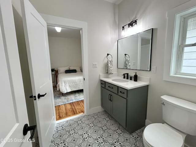 354 Mohawk Ave, Scotia, NY 12302 - ensuite bathroom featuring vanity, toilet, baseboards, and tile patterned flooring