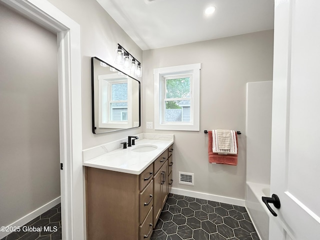 354 Mohawk Ave, Scotia, NY 12302 - full bathroom featuring vanity, baseboards, a tub, and tile patterned flooring