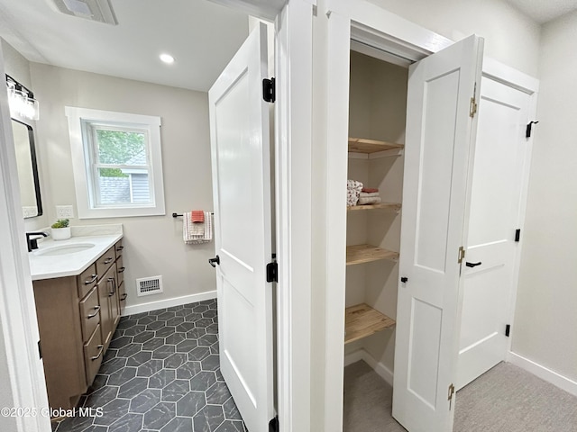354 Mohawk Ave, Scotia, NY 12302 - bathroom featuring vanity, baseboards, recessed lighting, and a closet