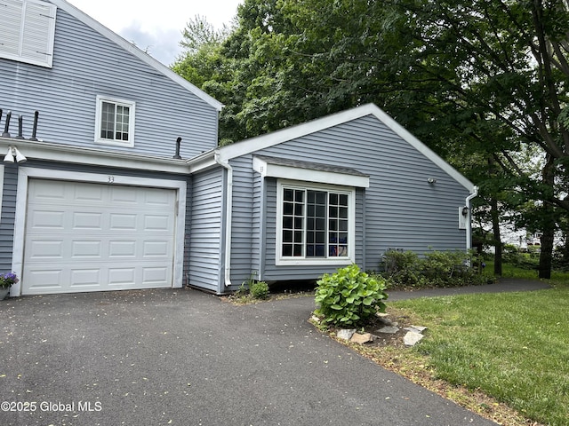 33 Oak Rd, Bethlehem, NY 12054 - view of side of home with an attached garage, driveway, and a lawn