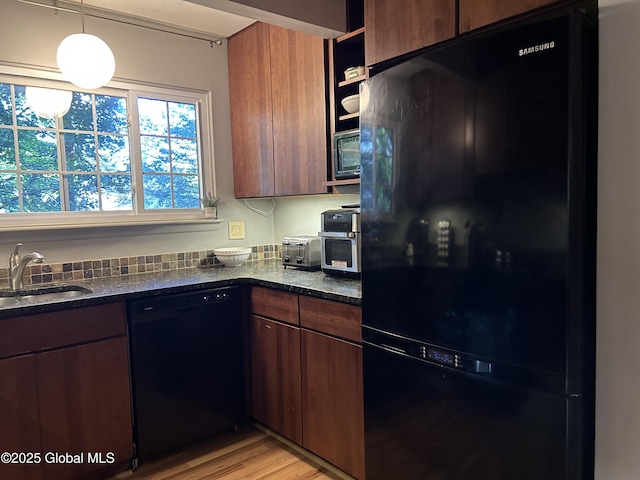 33 Oak Rd, Bethlehem, NY 12054 - kitchen featuring black appliances, a sink, light wood-type flooring, and dark stone counters