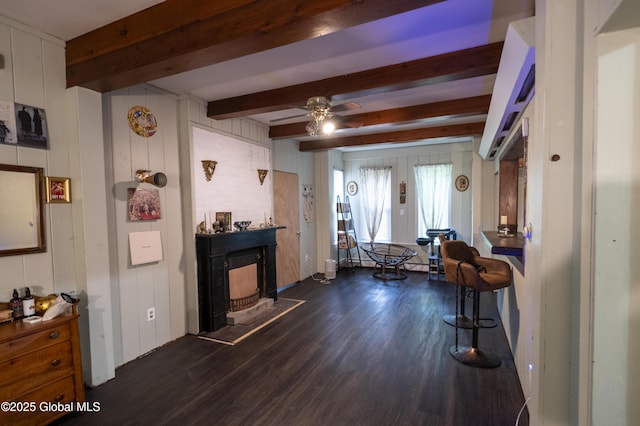 1356 W High St, Ballston Spa, NY 12020 - living room featuring dark wood finished floors, beamed ceiling, a fireplace, and a ceiling fan