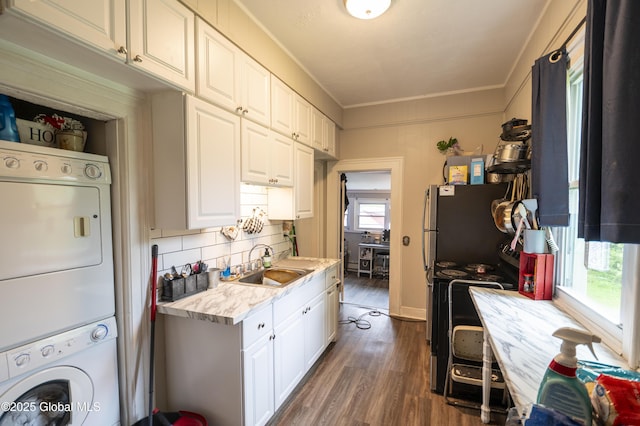 1356 W High St, Ballston Spa, NY 12020 - kitchen featuring stacked washing machine and dryer, light countertops, crown molding, dark wood-type flooring, and black range with electric cooktop