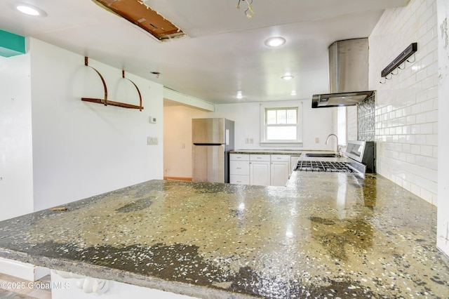 676 Stoner Trail Rd, Mohawk, NY 12068 - kitchen with freestanding refrigerator, range hood, a sink, dark stone counters, and recessed lighting