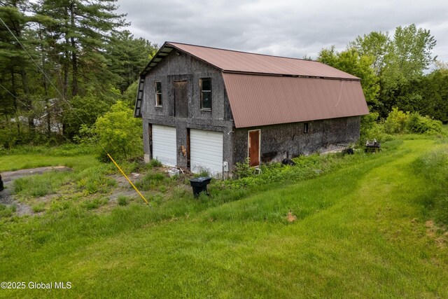 3194 State Route 9n, Greenfield, NY 12833 - view of side of home with a gambrel roof, a garage, metal roof, and an outbuilding