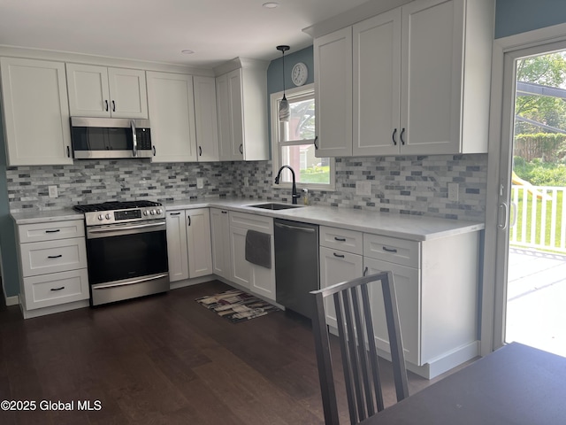 32 Old Sparrowbush Rd, Colonie, NY 12110 - kitchen with appliances with stainless steel finishes, a sink, light countertops, dark wood-style floors, and white cabinetry