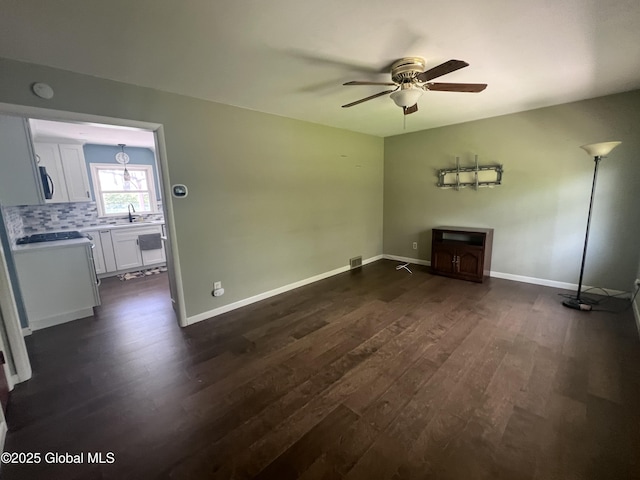 32 Old Sparrowbush Rd, Colonie, NY 12110 - unfurnished living room featuring dark wood-type flooring, ceiling fan, a sink, and baseboards