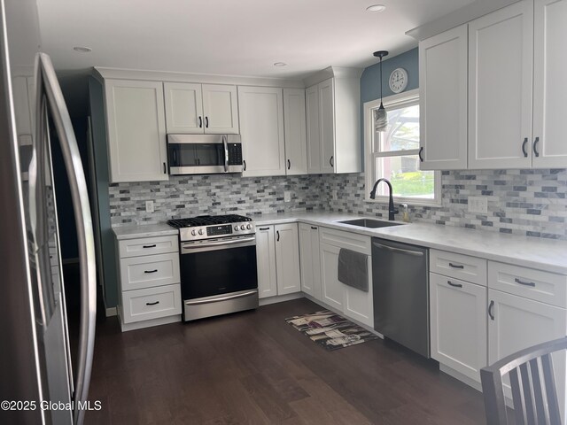 32 Old Sparrowbush Rd, Colonie, NY 12110 - kitchen with stainless steel appliances, a sink, dark wood-type flooring, white cabinets, and backsplash
