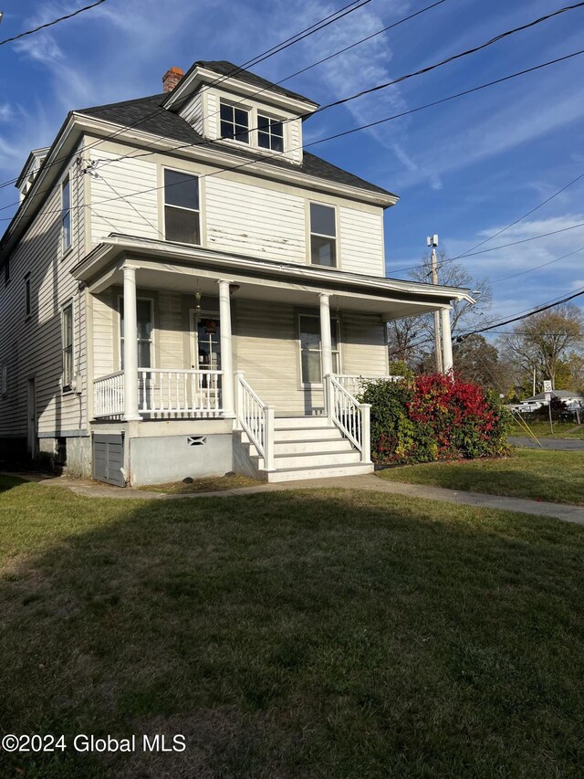 1643 Rugby Rd, Schenectady, NY 12309 - american foursquare style home with a porch, a chimney, and a front yard