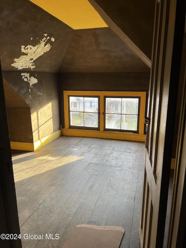 1643 Rugby Rd, Schenectady, NY 12309 - unfurnished living room with lofted ceiling, hardwood / wood-style floors, and baseboards