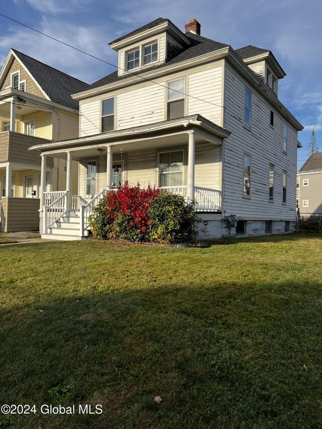 1643 Rugby Rd, Schenectady, NY 12309 - view of front of home with covered porch, a front yard, and a chimney
