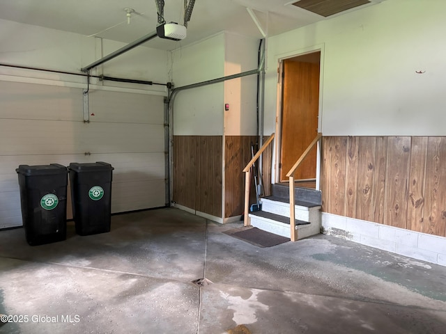 3 State Cir, Gloversville, NY 12078 - garage with a garage door opener, wainscoting, and wood walls
