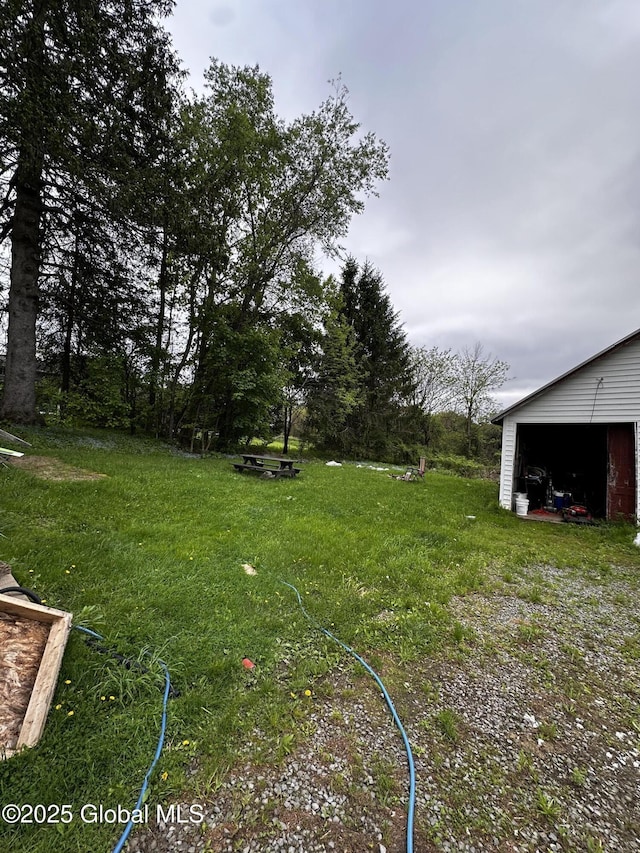 503 N Main St, Gloversville, NY 12078 - view of grassy yard with an outdoor structure and a garage