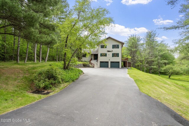 6175 Hawes Rd, Guilderland, NY 12009 - view of front of property featuring driveway, an attached garage, a front yard, and stairs