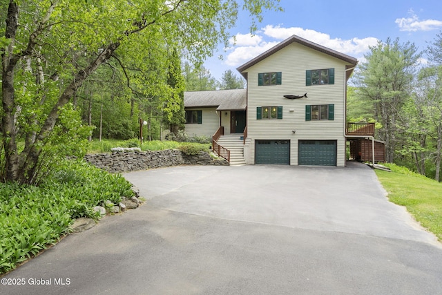 6175 Hawes Rd, Guilderland, NY 12009 - view of front of property with an attached garage, driveway, stairway, and roof with shingles
