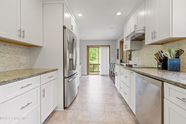 6175 Hawes Rd, Guilderland, NY 12009 - kitchen featuring stainless steel appliances, under cabinet range hood, white cabinetry, tasteful backsplash, and recessed lighting