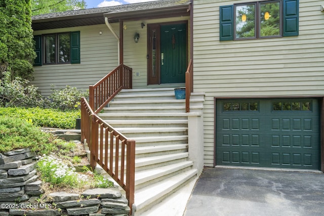 6175 Hawes Rd, Guilderland, NY 12009 - doorway to property featuring an attached garage and asphalt driveway