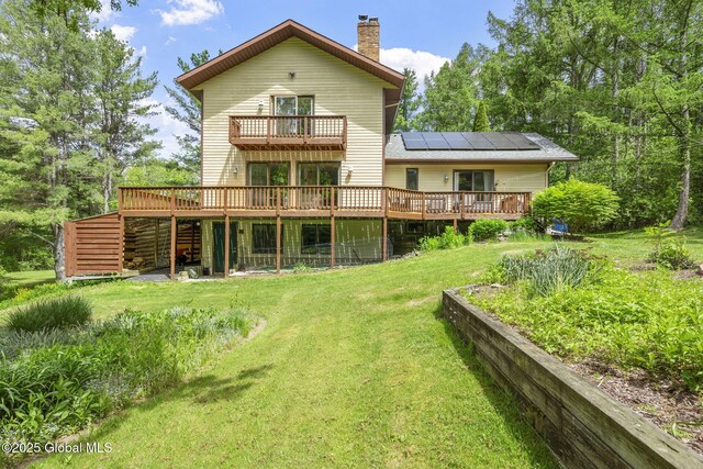 6175 Hawes Rd, Guilderland, NY 12009 - back of property featuring a chimney, a lawn, a balcony, and a wooden deck