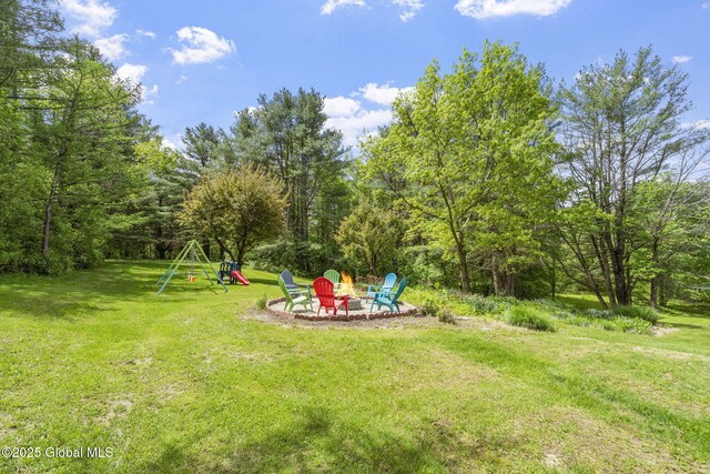 6175 Hawes Rd, Guilderland, NY 12009 - view of grassy yard with a playground and a fire pit