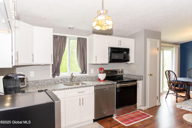 126 Hillside Rd, Duanesburg, NY 12137 - kitchen featuring appliances with stainless steel finishes, a sink, dark wood finished floors, white cabinetry, and decorative light fixtures