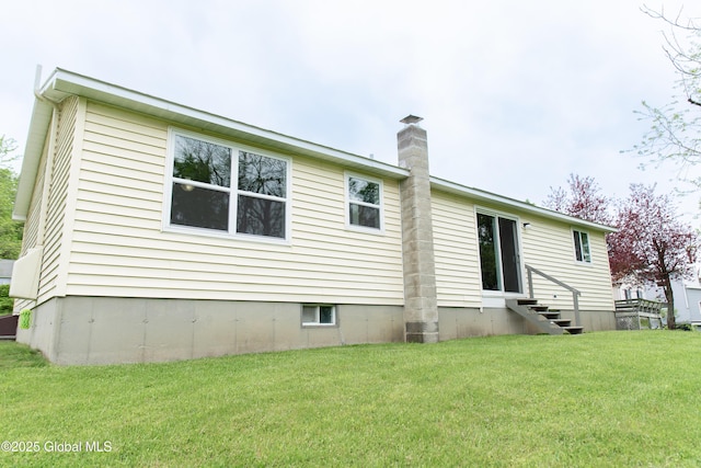126 Hillside Rd, Duanesburg, NY 12137 - rear view of property featuring entry steps, a chimney, and a lawn