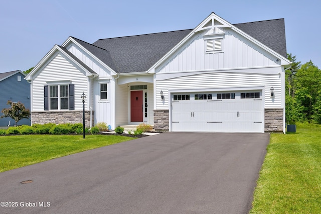 39 Berkeley Way, Wilton, NY 12866 - view of front of property with stone siding, board and batten siding, driveway, and an attached garage