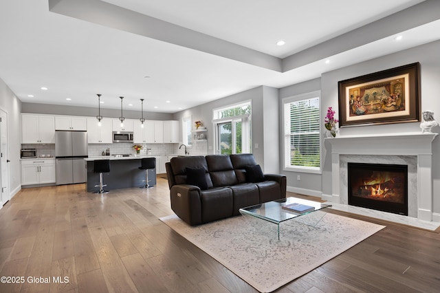 39 Berkeley Way, Wilton, NY 12866 - living room featuring light wood finished floors, a fireplace, and recessed lighting