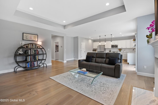 39 Berkeley Way, Wilton, NY 12866 - living room with a tray ceiling, light wood-style floors, and recessed lighting