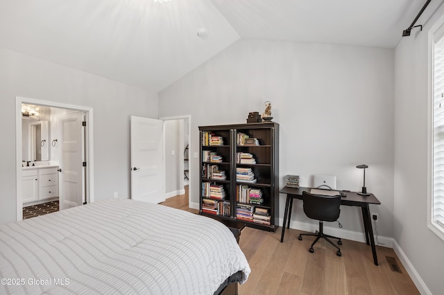 39 Berkeley Way, Wilton, NY 12866 - bedroom featuring light wood finished floors, vaulted ceiling, an office area, and ensuite bath