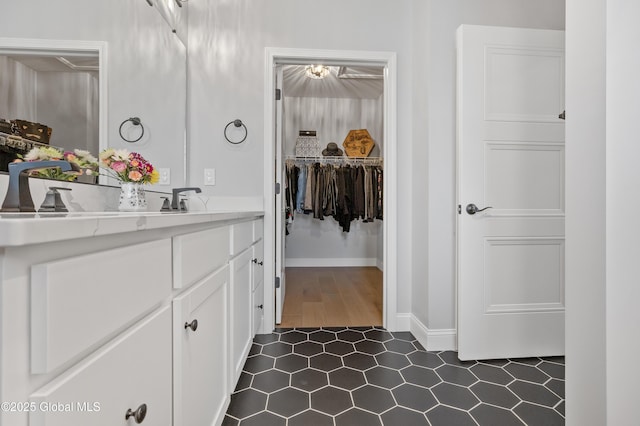 39 Berkeley Way, Wilton, NY 12866 - bathroom featuring vanity, tile patterned flooring, and a walk in closet