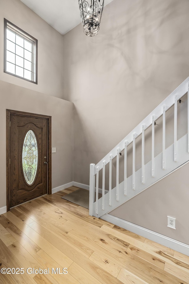 110 Deer Run Dr, Milton, NY 12020 - entrance foyer with hardwood / wood-style flooring, baseboards, a chandelier, and a towering ceiling