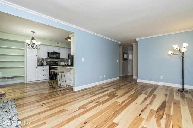 110 Deer Run Dr, Milton, NY 12020 - unfurnished living room with crown molding, a chandelier, light wood finished floors, and baseboards