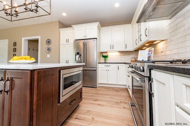 5 Hunter Ct, Milton, NY 12020 - kitchen featuring high end appliances, range hood, white cabinetry, a chandelier, and recessed lighting