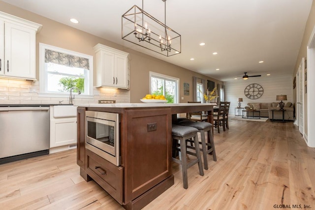 5 Hunter Ct, Milton, NY 12020 - kitchen featuring stainless steel appliances, open floor plan, a kitchen island, white cabinetry, and recessed lighting